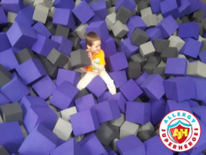 Kal having fun with foam blocks at a food allergy inclusive birthday party by Allergy Superheroes.