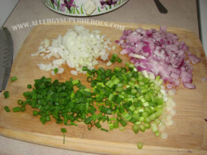 Chopped white, red, and green onions on wooden cutting board for soup garnish | by Food Allergy Superheroes
