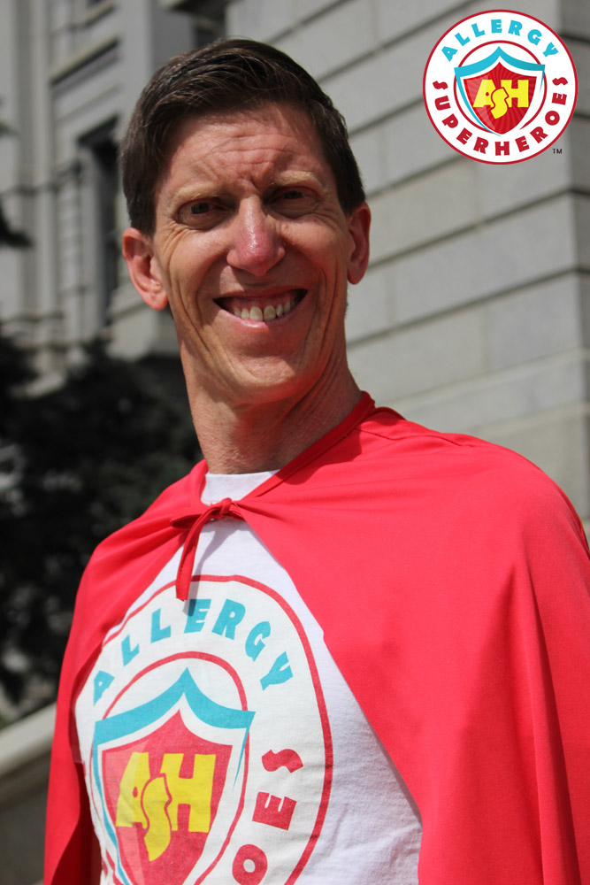 Dean of Allergy Superheroes, in a cape, standing outside of the Colorado State Capitol | by Food Allergy Superheroes