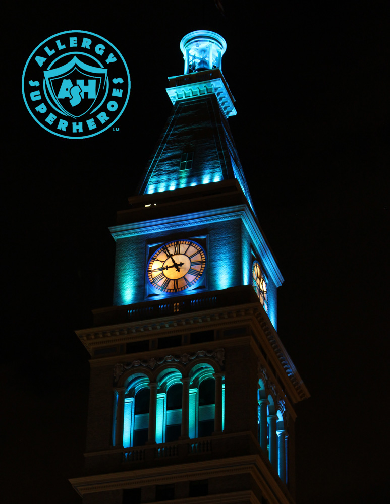 Denver's D&F Clock Tower on 16th Street Mall, with the top floors lit up Teal for Food Allergy Awareness | by Food Allergy Superheroes