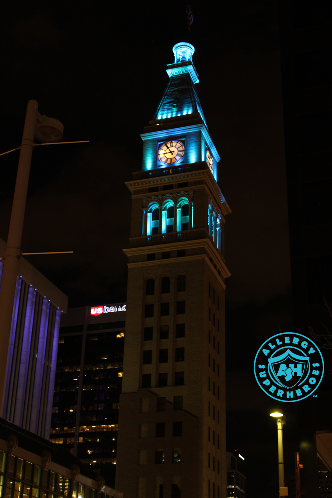 Denver's D&F Clock Tower on 16th Street Mall tall shot, with the top floors lit up Teal for Food Allergy Awareness | by Food Allergy Superheroes