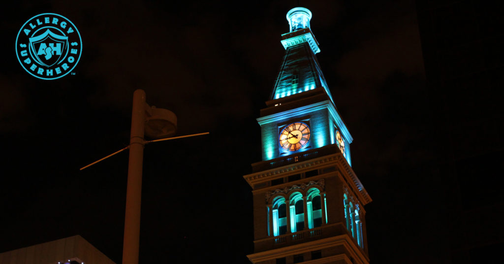 Denver's D&F Clock Tower on 16th Street Mall wide shot, with the top floors lit up Teal for Food Allergy Awareness | by Food Allergy Superheroes