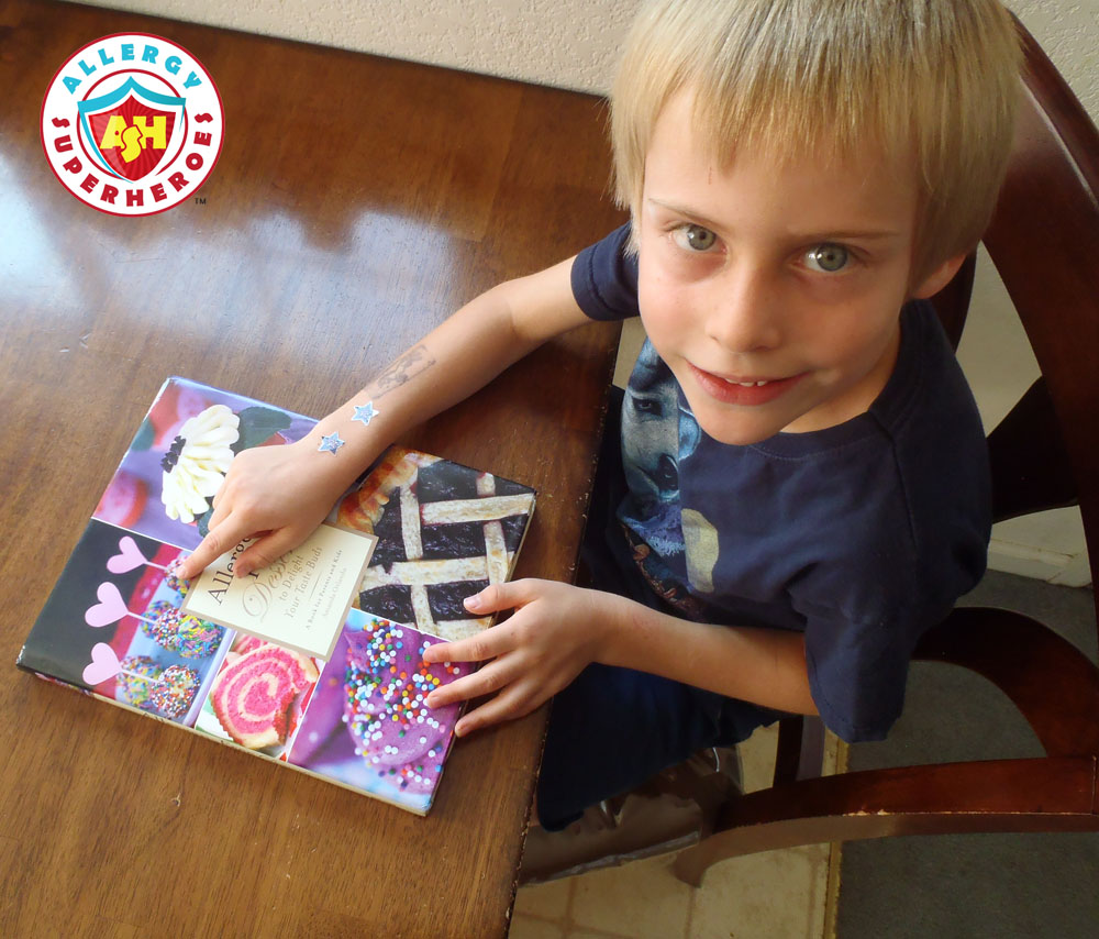 Child pointing to Cake Balls on cover of cookbook | Cookbook Review | Allergen Free Desserts | Food Allergy Superheroes